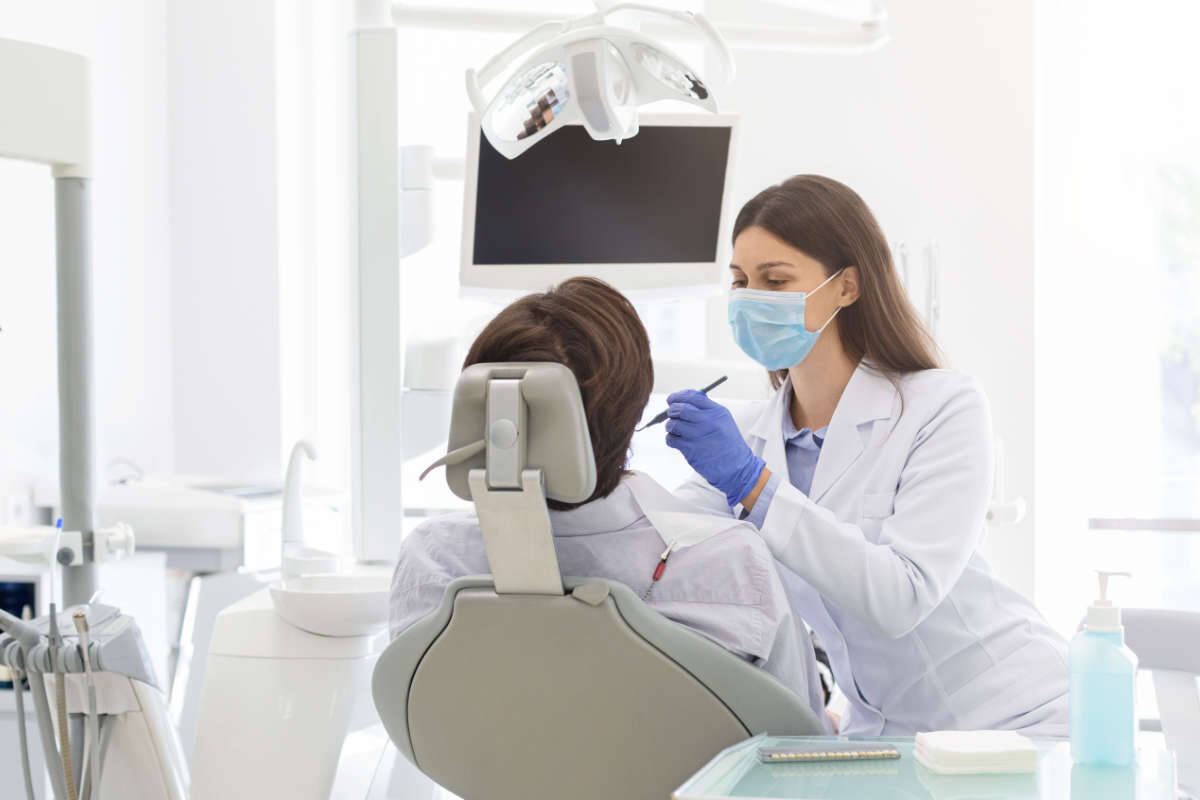 Dentist working with a patient to give them a gleaming smile