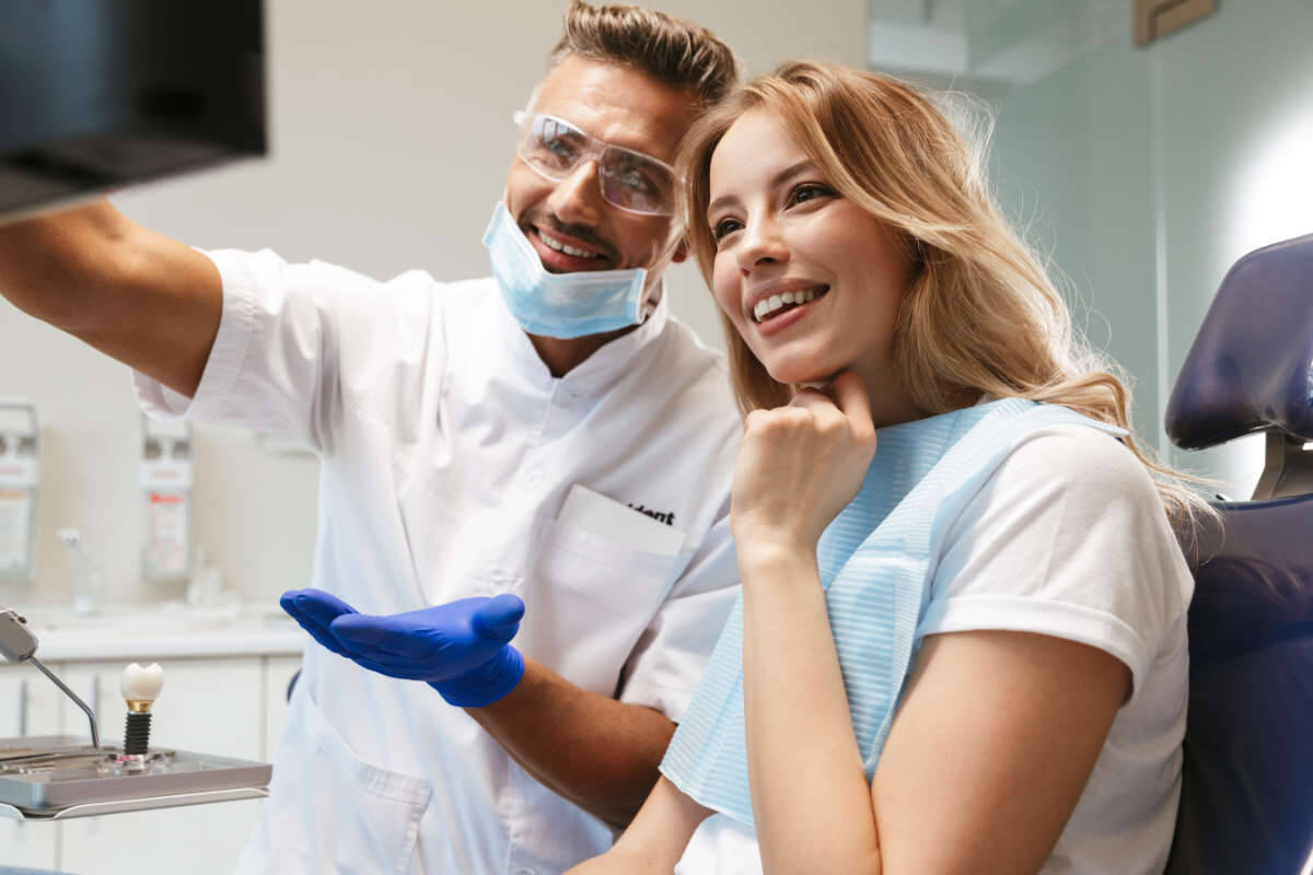 Happy patient looking at an x-ray of their healthy teeth