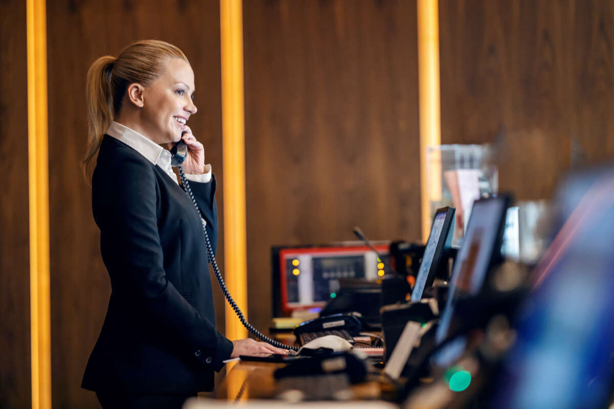 Hotel staff talking on phone to guest
